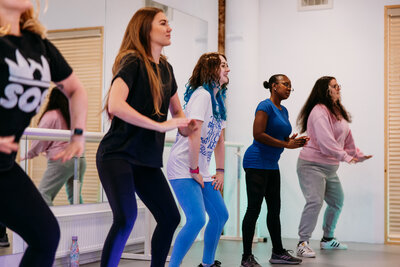 Group lined up and dancing in a studio 