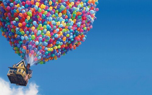 A still from the movie Up showing a house lifted into the air by balloons