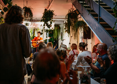 Customers enjoying musician's performance