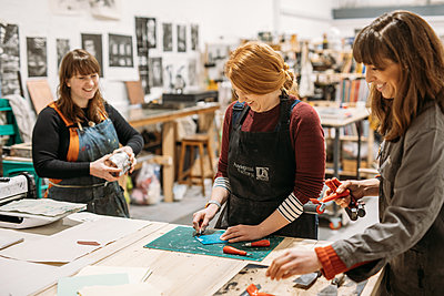 women in a printmaking workshop etching 