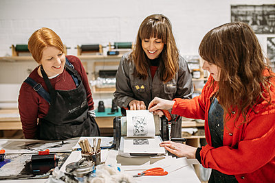 group looking at a print in a workshop