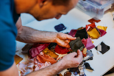 Guest looking at examples of dyed fabrics 