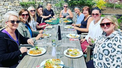 Guests smile for photo as they enjoy their meals