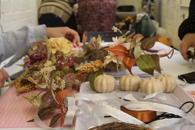 Guests look through dried flowers and other materials used to make autumn wreath