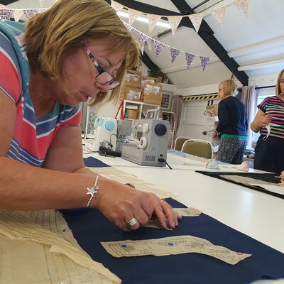 Guest arranges pattern pieces on fabric