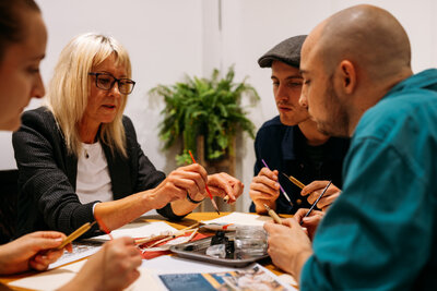 Host guides guests through calligraphy processes