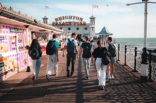 Two people looking into the distance over Brighton seafront