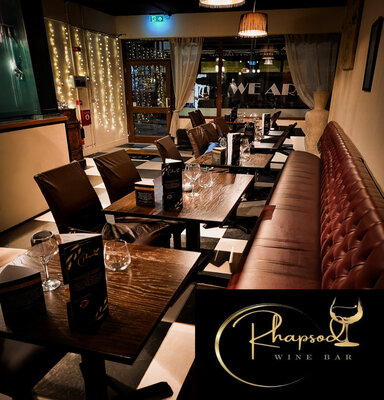 Cosy wine bar with elegant seating and ambient lighting.