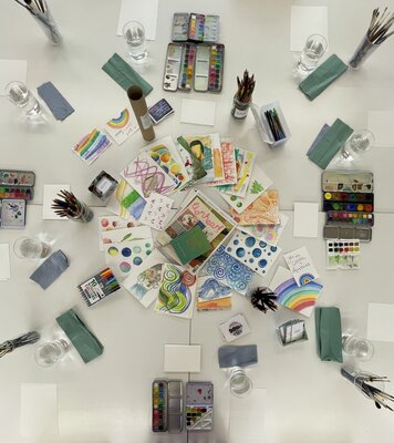 Colourful art supplies and creative sketches ready for a fun-filled workshop.