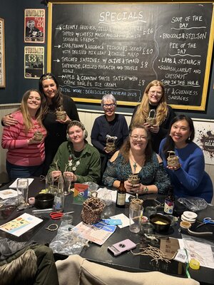 Joyful crafting session with friends showcasing their woven basket creations