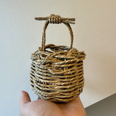 Charming handwoven basket held aloft