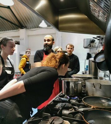 Cheery chefs bonding over a bubbling pot