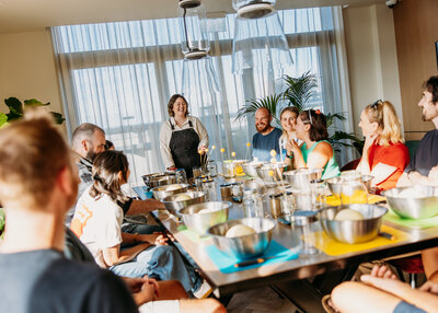 Happy group enjoying a baking class together at a sunny table