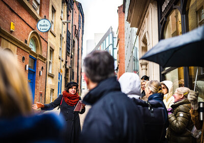 Tour guide leading a lively stroll down Bottle Lane.