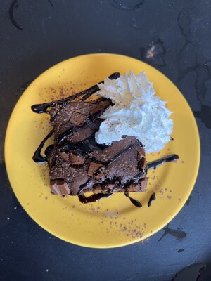 Decadent chocolate brownie with a swirl of cream delight