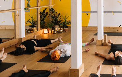Relaxing yoga class in a cosy, candlelit studio.