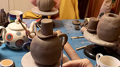 Craft table with decorative teapot models on
